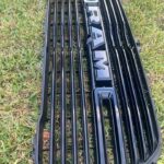 Glossy black RAM 1500 front grille with large integrated RAM lettering